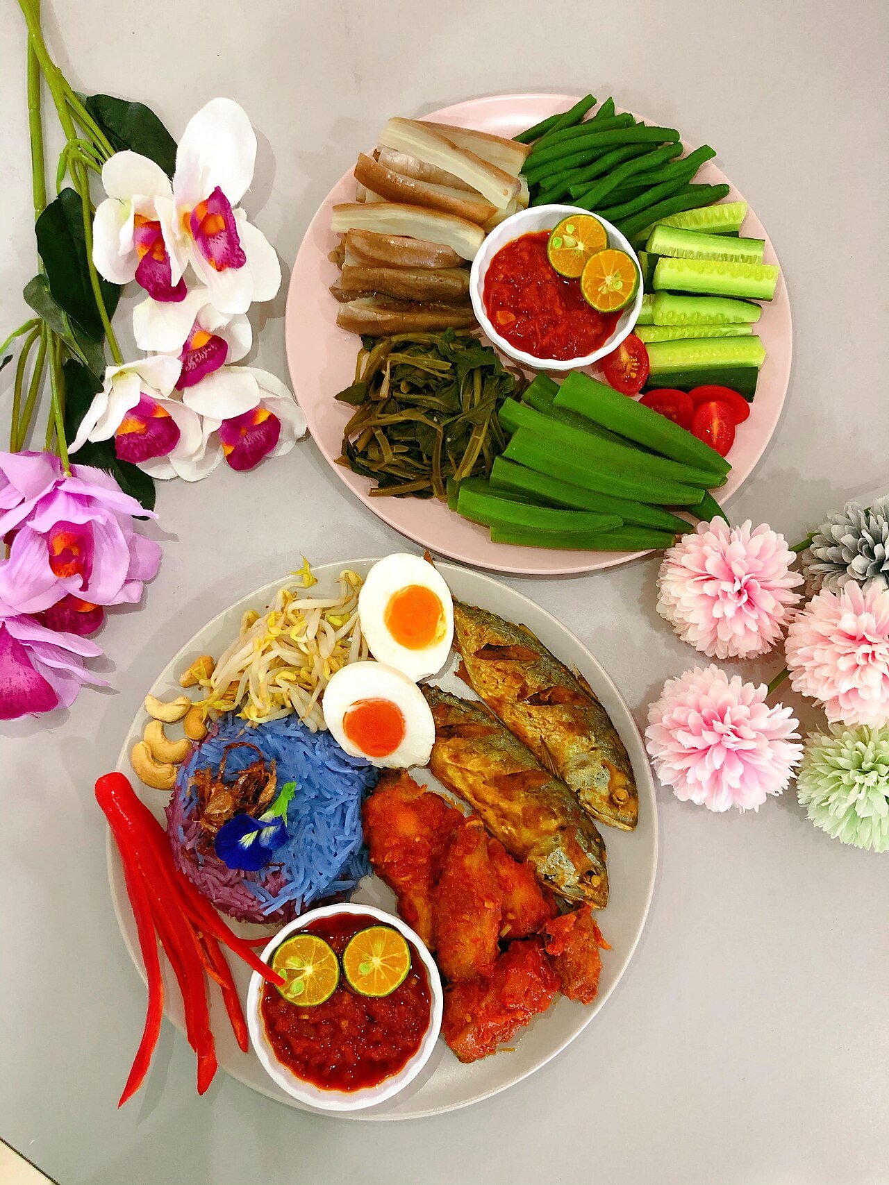 Nasi kerabu served with traditional ulam-ulaman