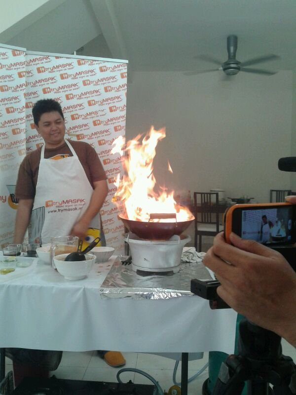The TryMasak founder demonstrating a flambe cooking technique at a live event, the early roots of what became iCookAsia