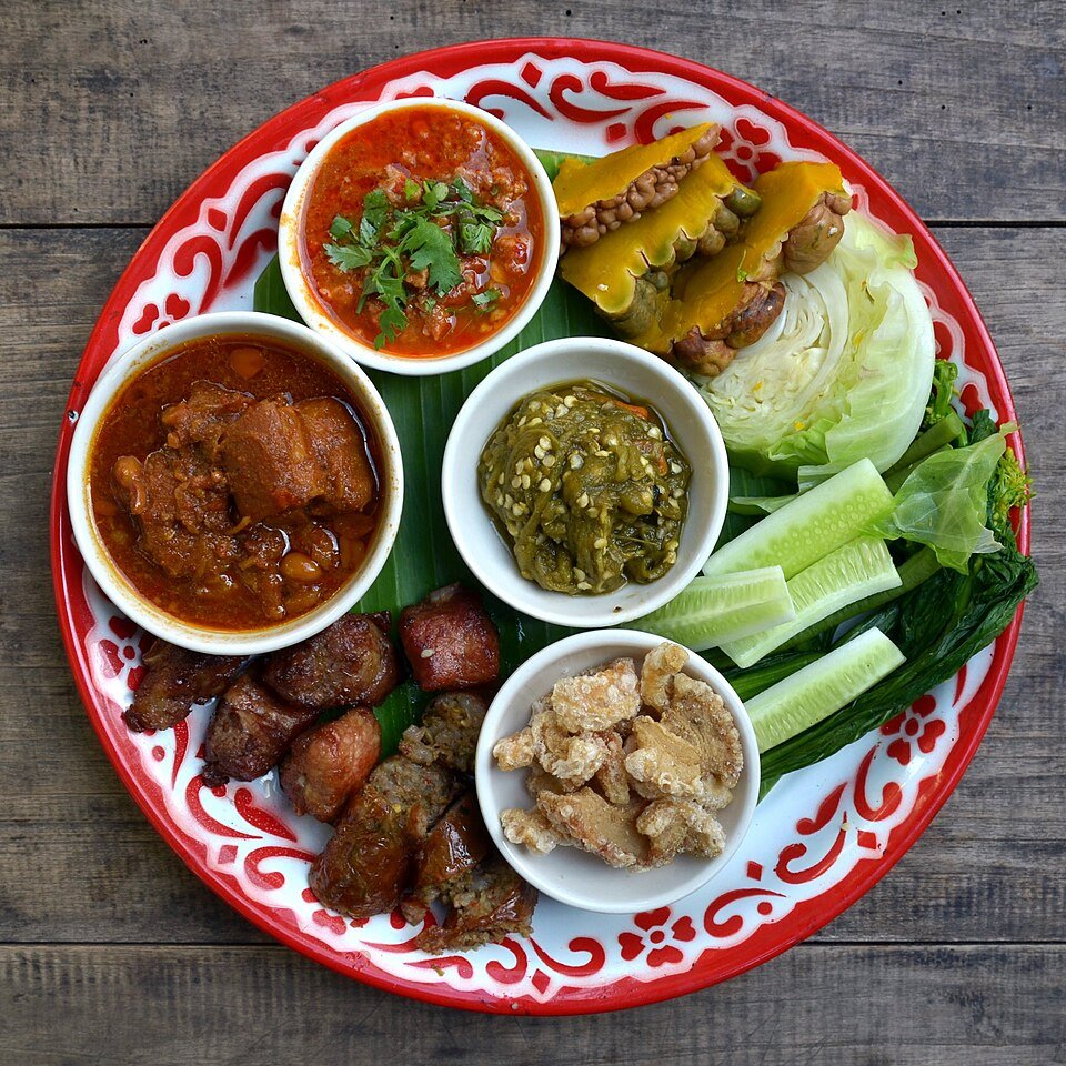 Northern Thai Lanna appetisers with chilli dips, vegetables and sausage