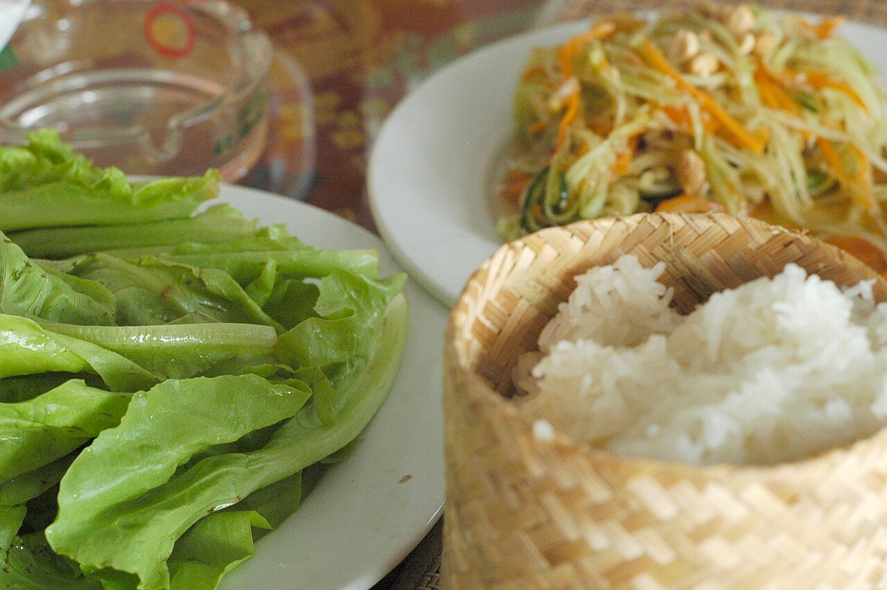 Lao sticky rice, green papaya salad and lettuce served together in Vientiane
