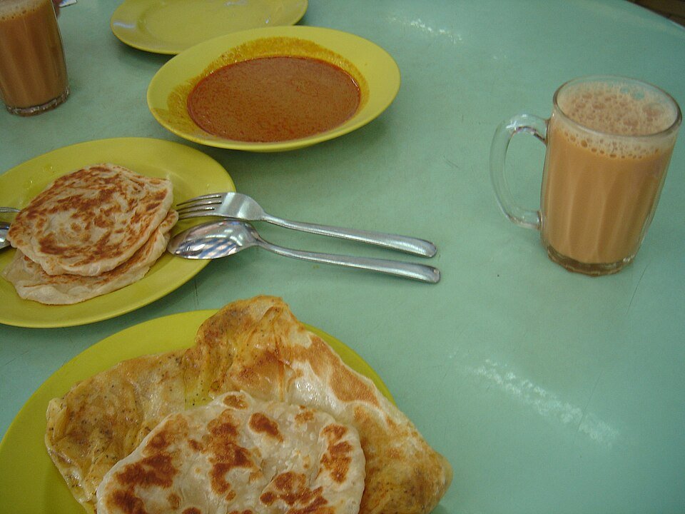 Roti canai bersama kari dan segelas teh di Malaysia