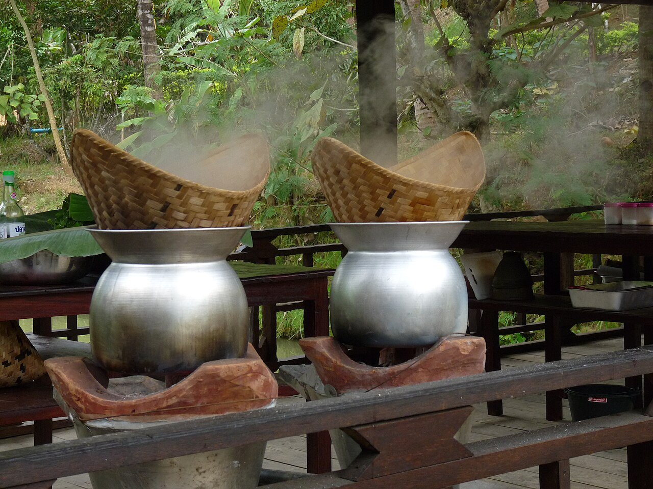 Lao sticky rice being steamed in traditional bamboo baskets in Luang Prabang
