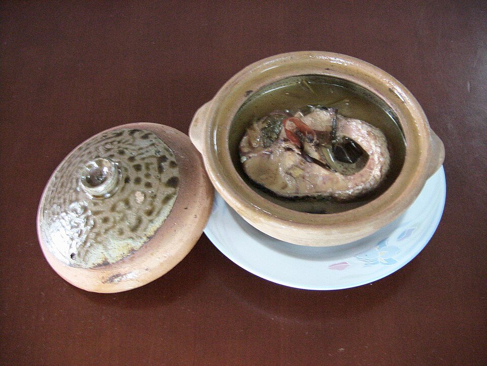 Vietnamese braised fish served in a dark clay pot