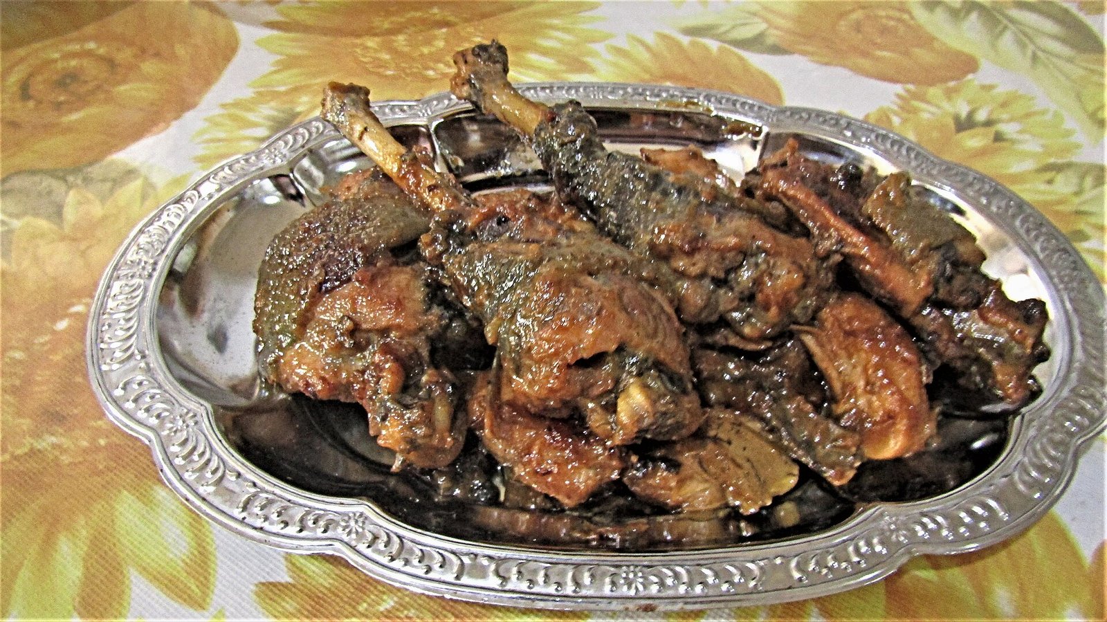 Chicken adobo with coconut milk arranged on an oval serving tray