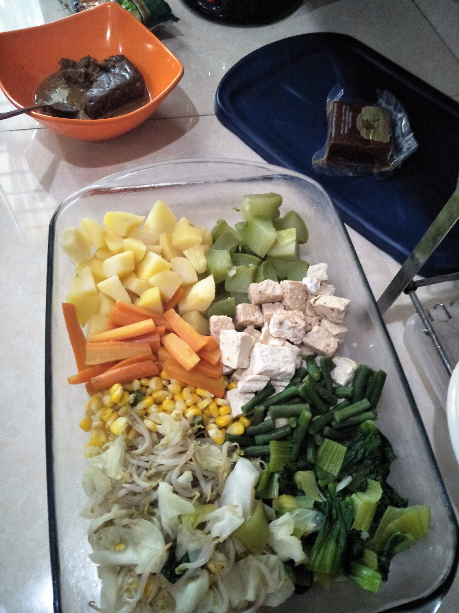 Prepared vegetables and tofu arranged before peanut sauce is added