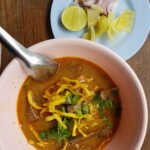 Beef khao soi in Chiang Mai with crisp noodles and condiments