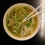 Vietnamese pho in Ho Chi Minh City with rice noodles and herbs
