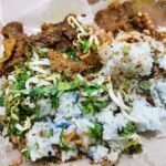 Nasi ulam bersama daging bakar, herba cincang dan taugeh