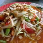 Som tam green papaya salad with peanuts and tomatoes in Yasothon