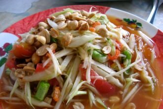 Som tam green papaya salad with peanuts and tomatoes in Yasothon