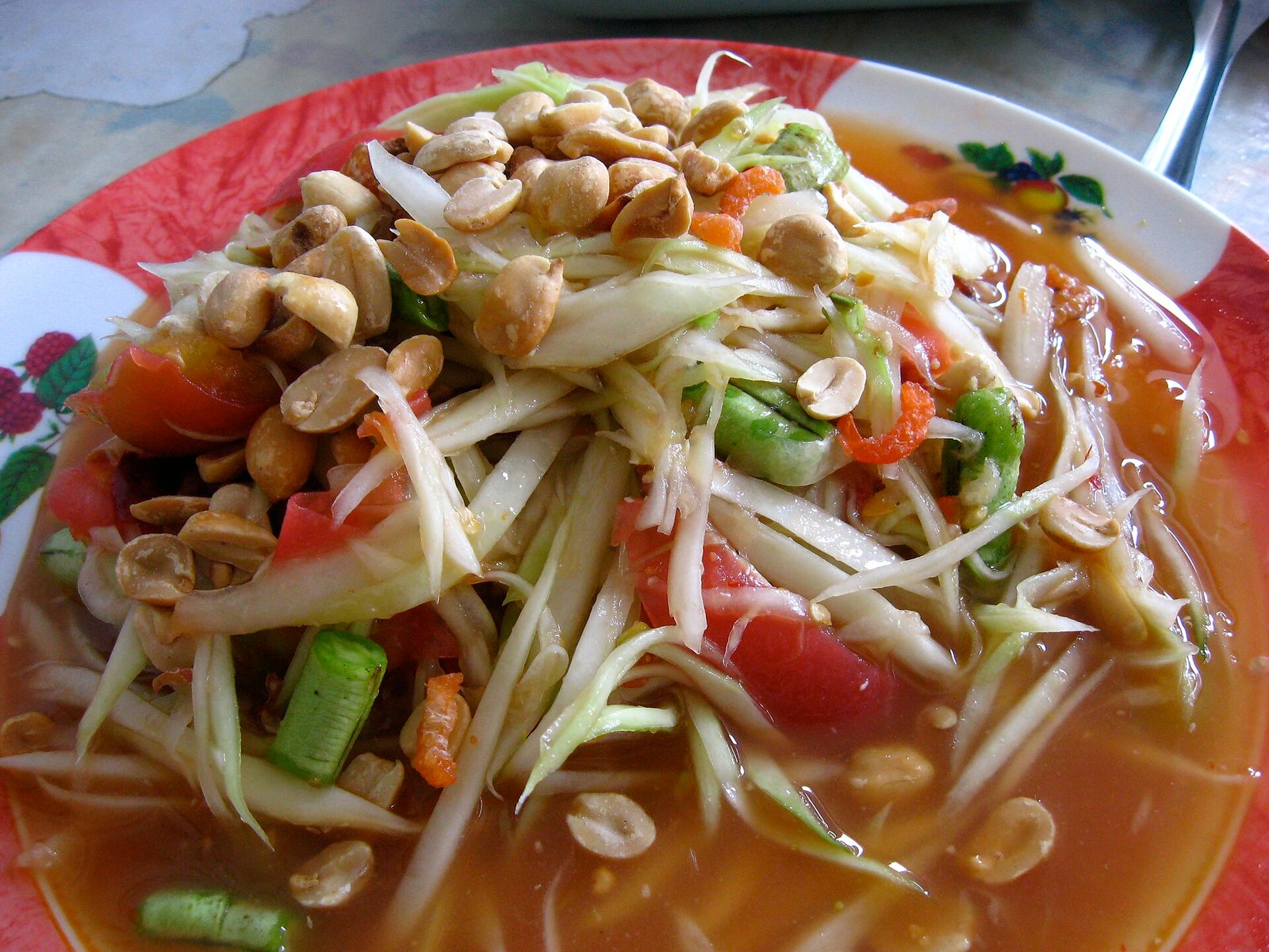 Som tam green papaya salad with peanuts and tomatoes in Yasothon