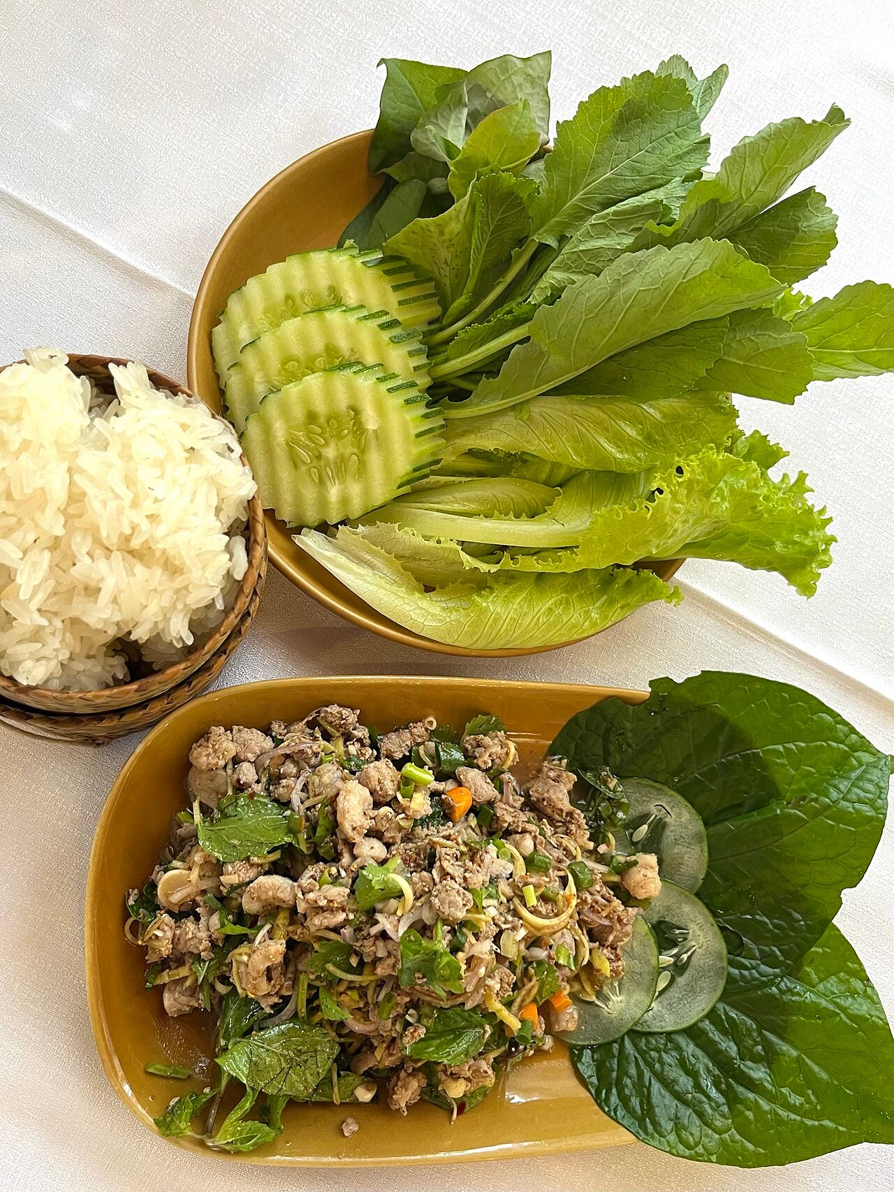 Lao fish larb with sticky rice and fresh vegetables