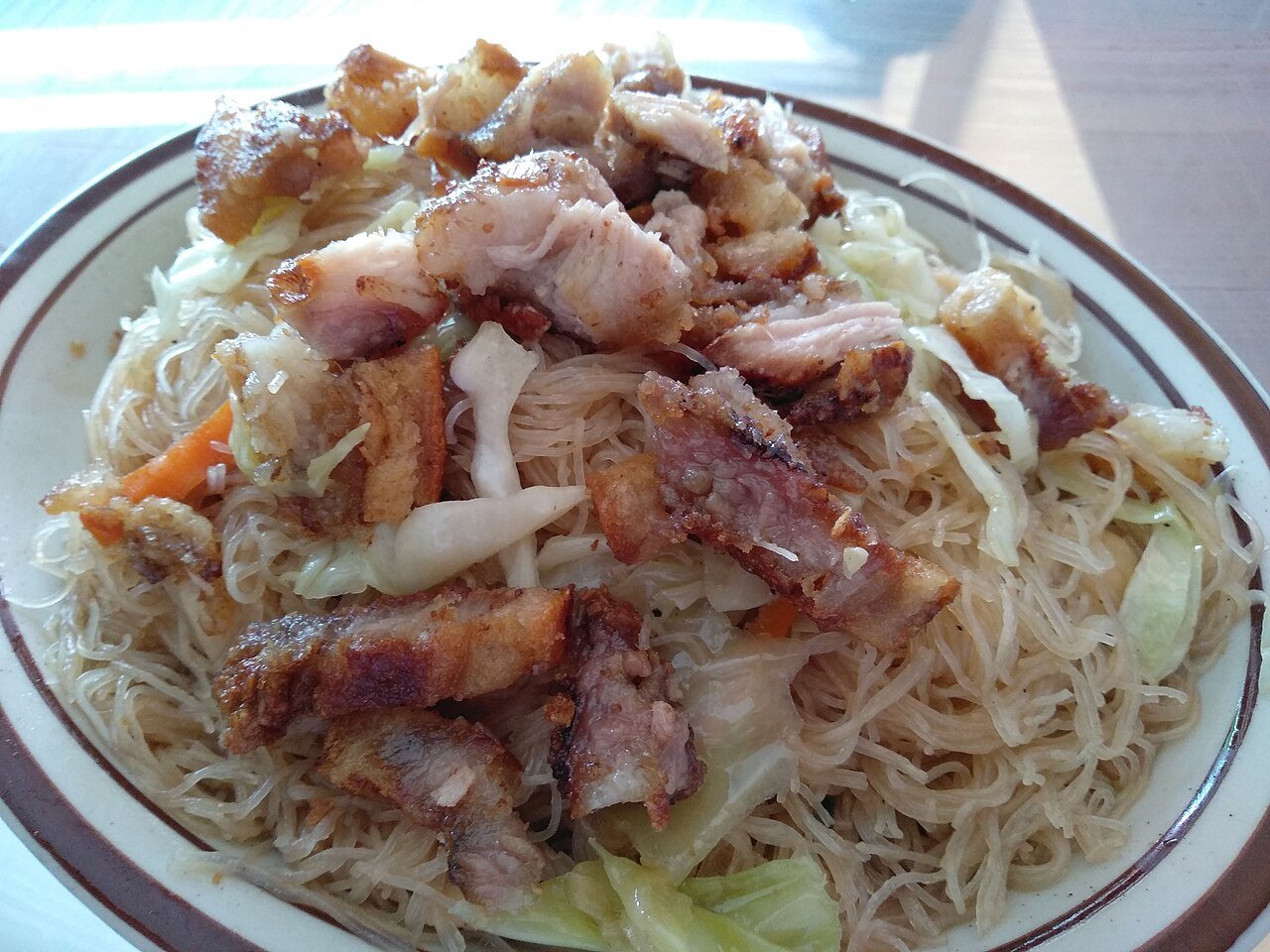 Pancit bihon rice noodles served on a plate