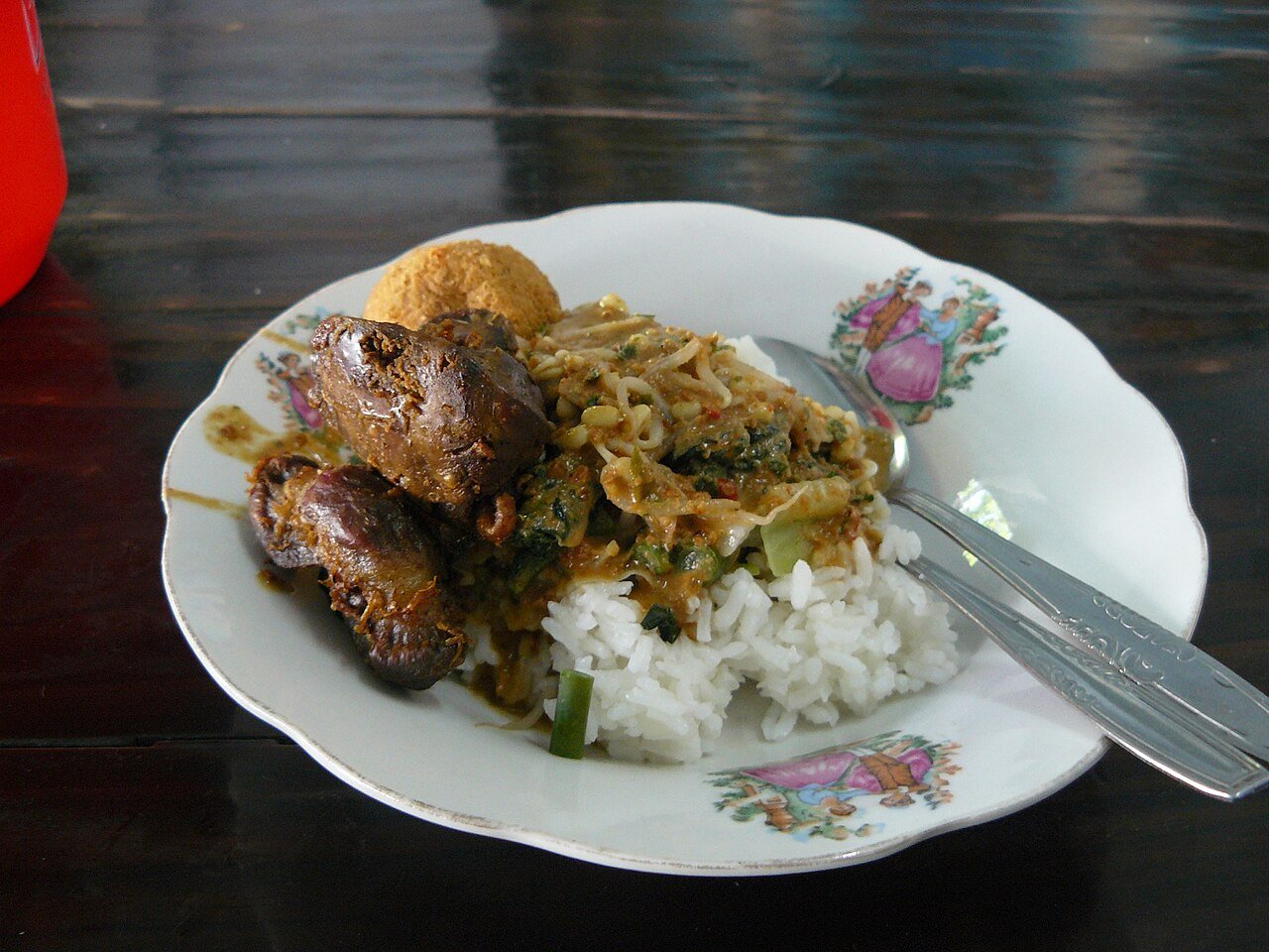 Madiun-style nasi pecel with rice, vegetables and sides, photographed in Malang